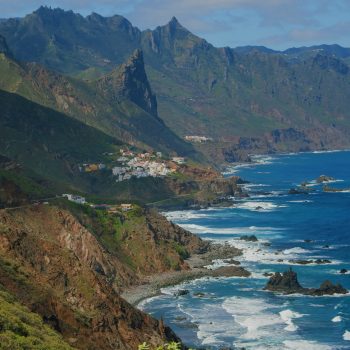 Playa del Roque de las Bodegas, north of Tenerife, Spain. Green coastline, Atlantic Ocean and cute town or village Almaciga. Rocky coast and Almaciga beach in Tenerife, The Canaries. Spain. Scenic view. Sunny and colourful day. Real time shot, high quality footage.